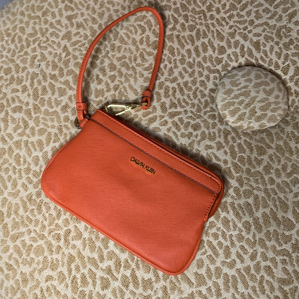Orange Calvin Klein wristlet. Brand new.
